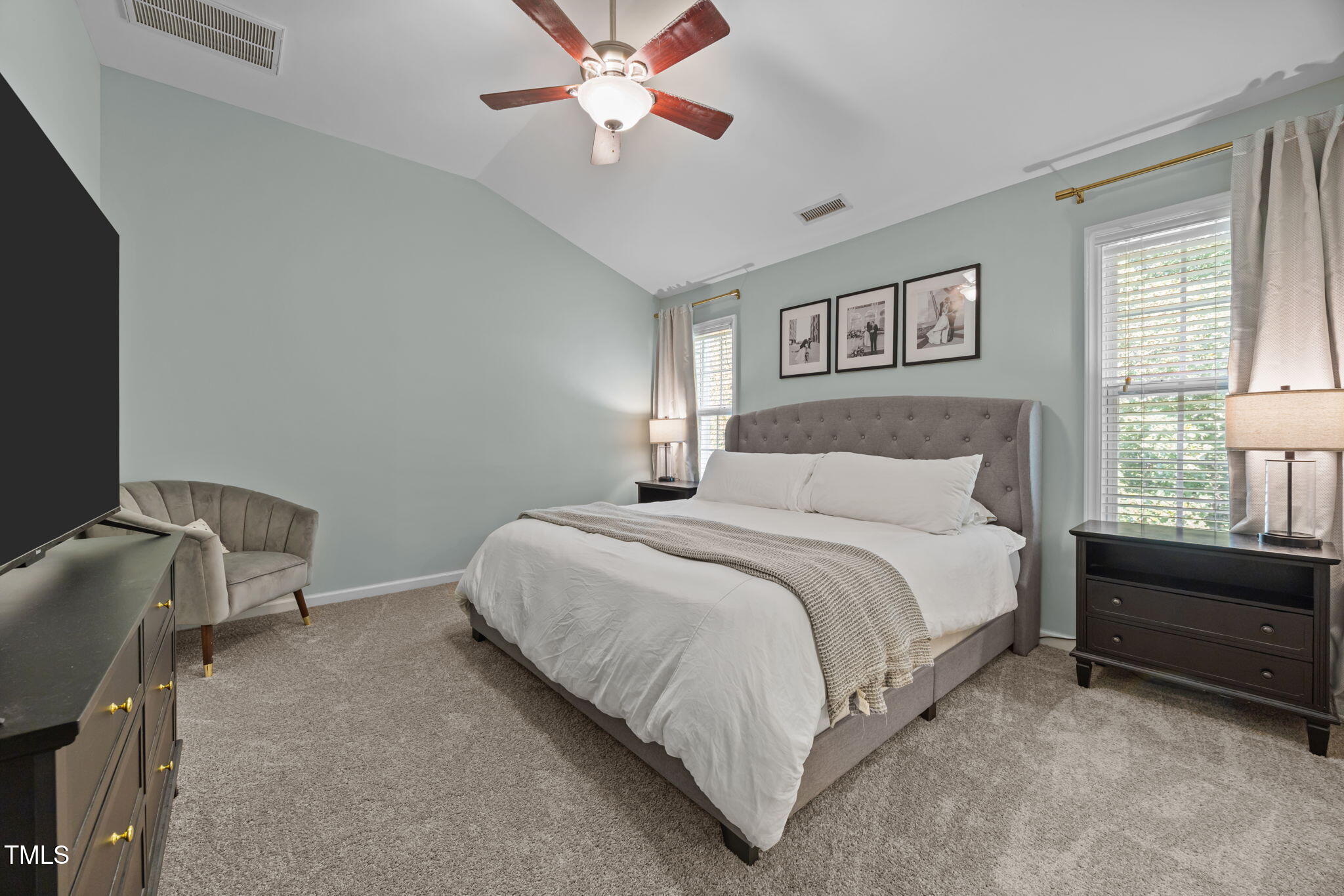 6825 Middleboro Drive Raleigh, NC 27612 - Photo 24 of 38 a bedroom with a bed and a chandelier