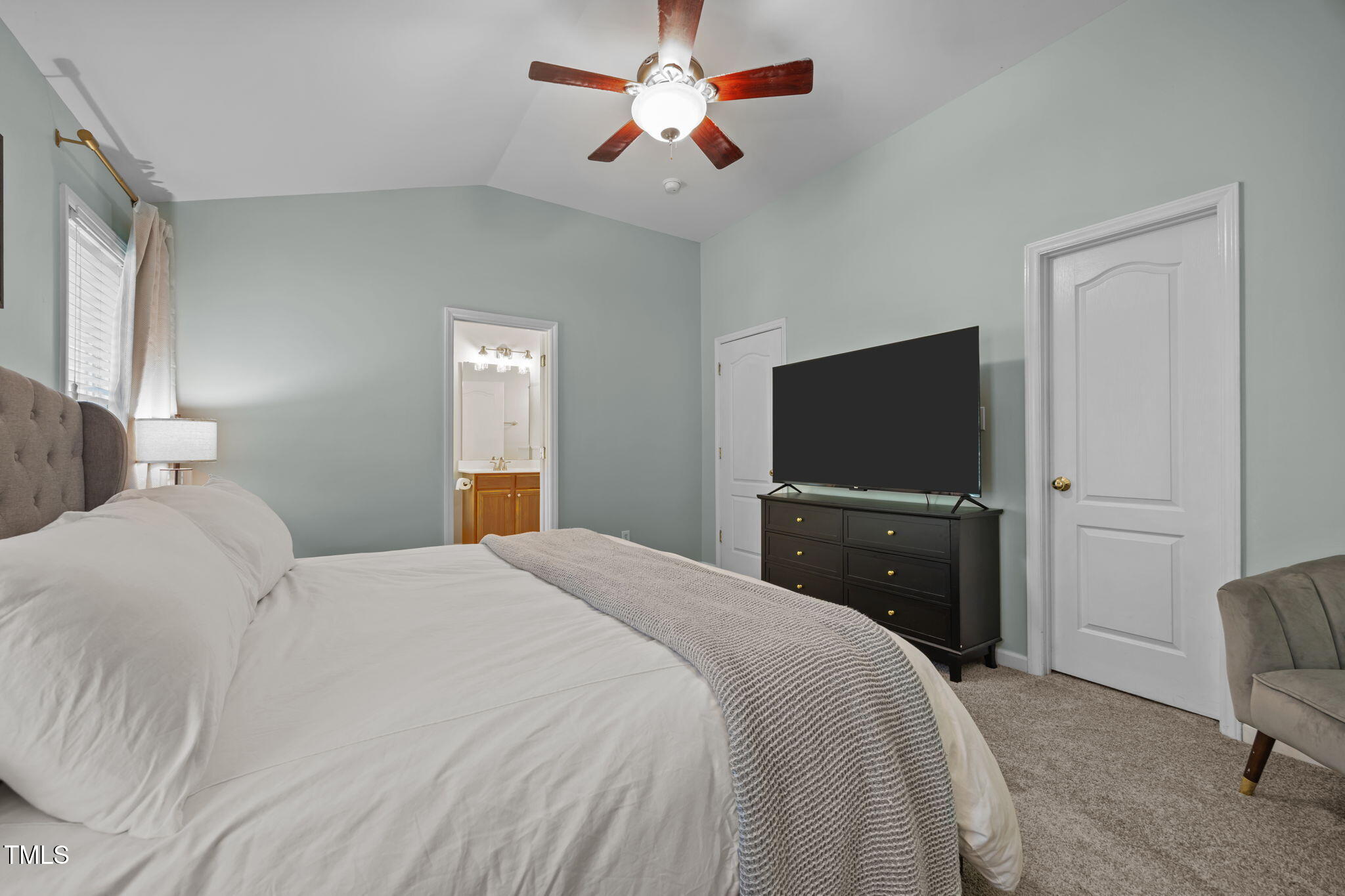 6825 Middleboro Drive Raleigh, NC 27612 - Photo 25 of 38 a bedroom with a bed and a flat screen tv