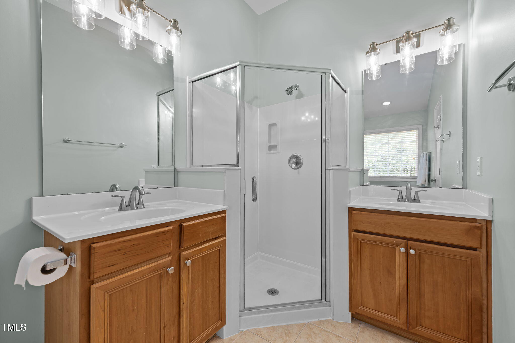6825 Middleboro Drive Raleigh, NC 27612 - Photo 26 of 38 a bathroom with a sink vanity granite shower and a mirror