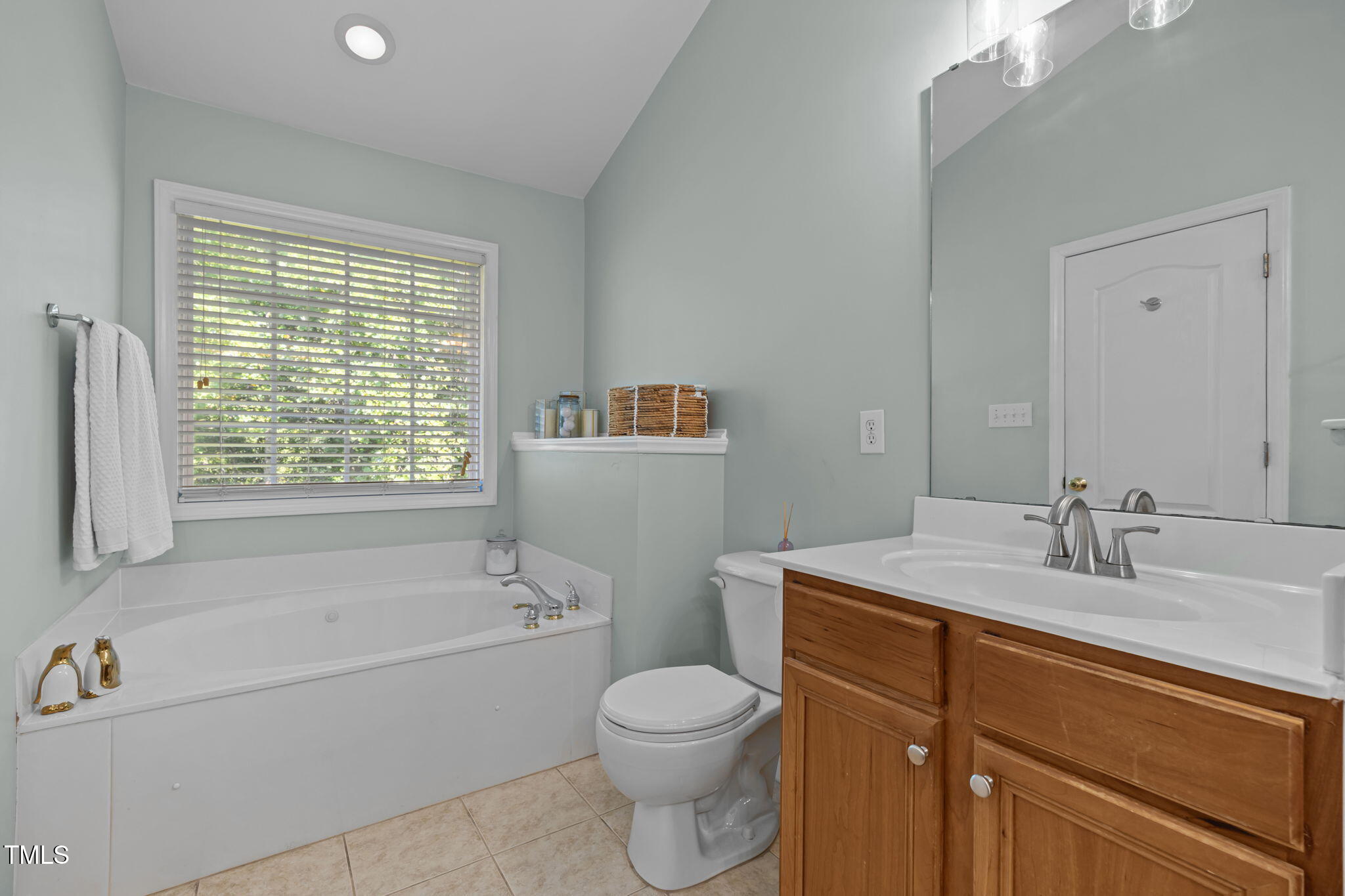 6825 Middleboro Drive Raleigh, NC 27612 - Photo 27 of 38 a bathroom with a granite countertop toilet a sink and a bathtub