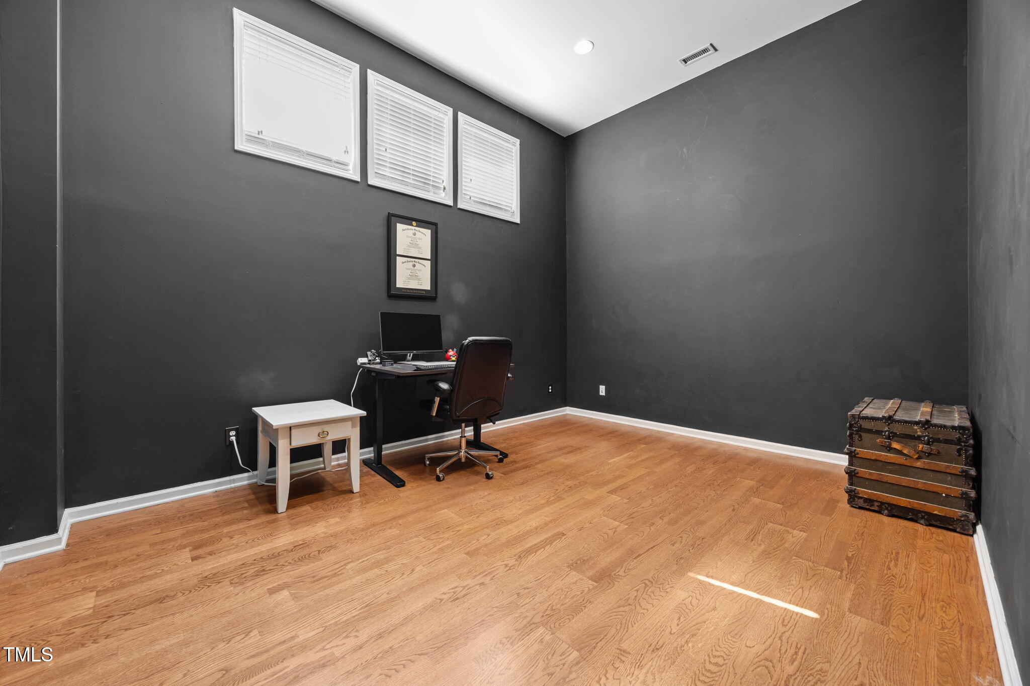 6825 Middleboro Drive Raleigh, NC 27612 - Photo 35 of 38 a room with a chair and wooden floor