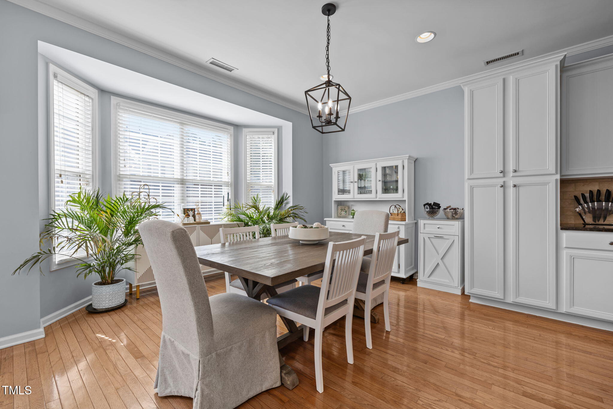 6825 Middleboro Drive Raleigh, NC 27612 - Photo 6 of 38 a view of a dining room with furniture window and wooden floor
