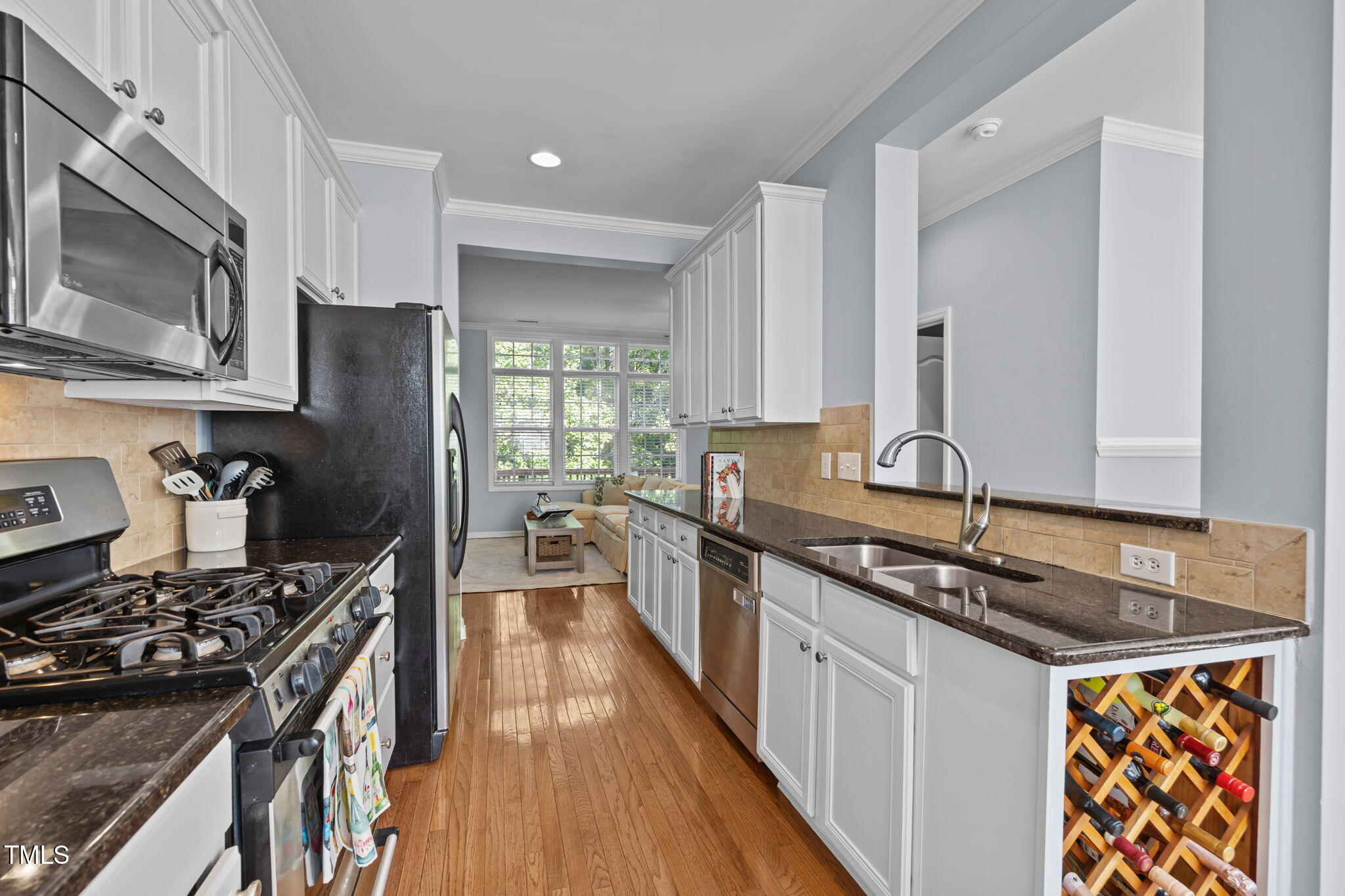 6825 Middleboro Drive Raleigh, NC 27612 - Photo 8 of 38 a kitchen with stainless steel appliances granite countertop a stove sink and cabinets