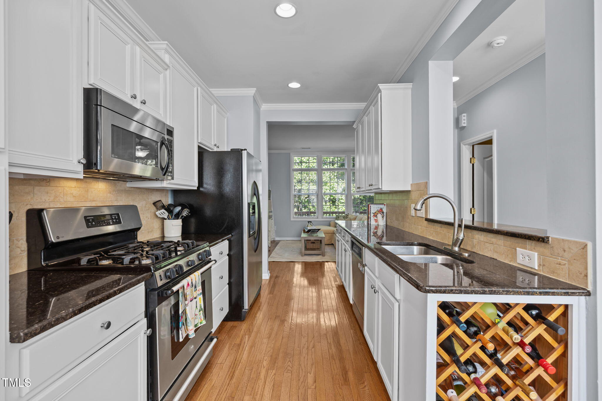 6825 Middleboro Drive Raleigh, NC 27612 - Photo 9 of 38 a kitchen with granite countertop a sink stove refrigerator and cabinets