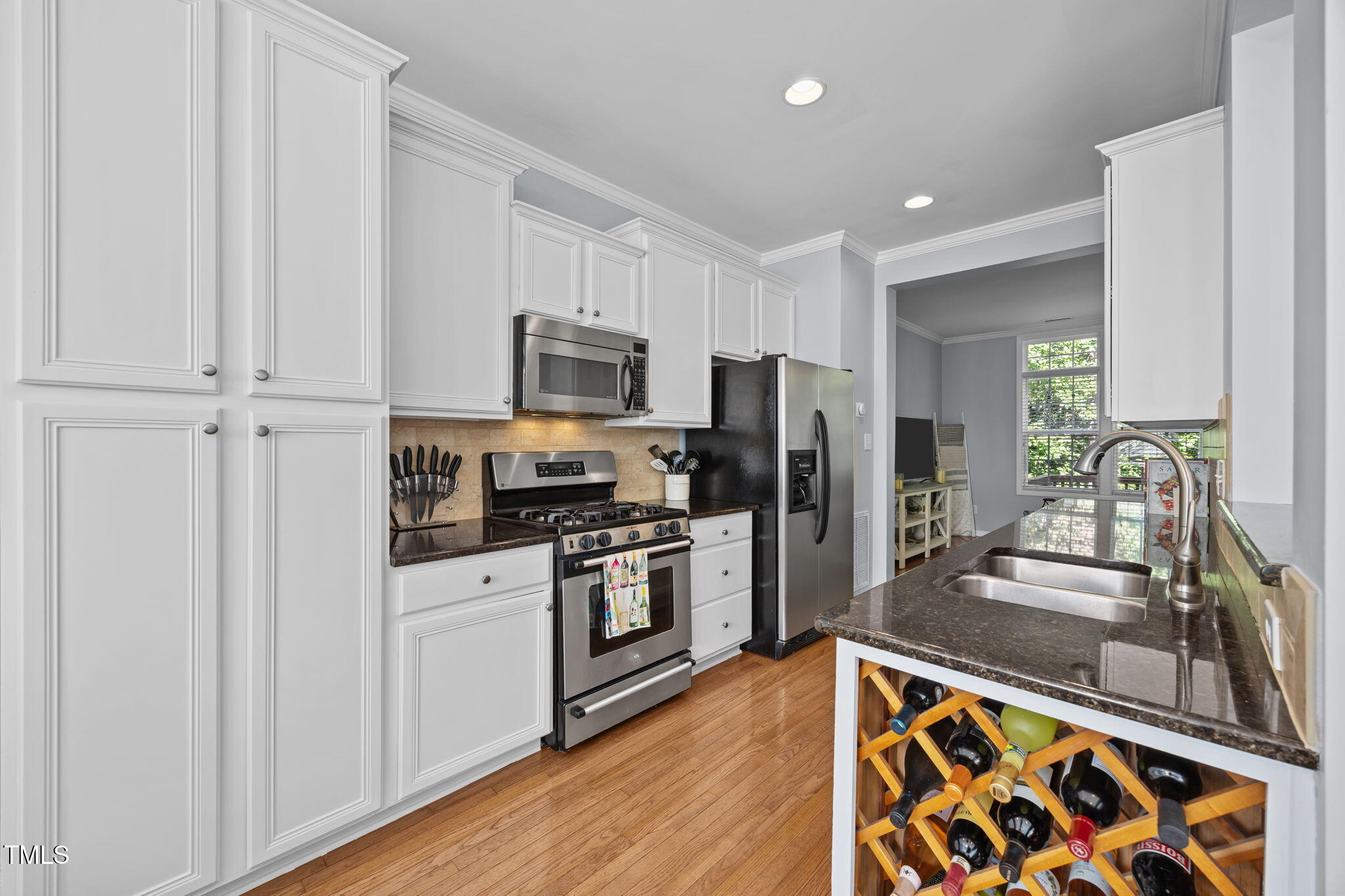 6825 Middleboro Drive Raleigh, NC 27612 - Photo 10 of 38 a kitchen with a refrigerator stove and sink