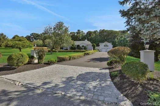 a view of a street with a house in the background