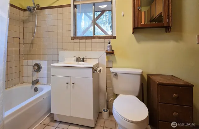 a white toilet sitting next to a bathroom sink