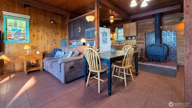 a living room with furniture and a dining table with chairs