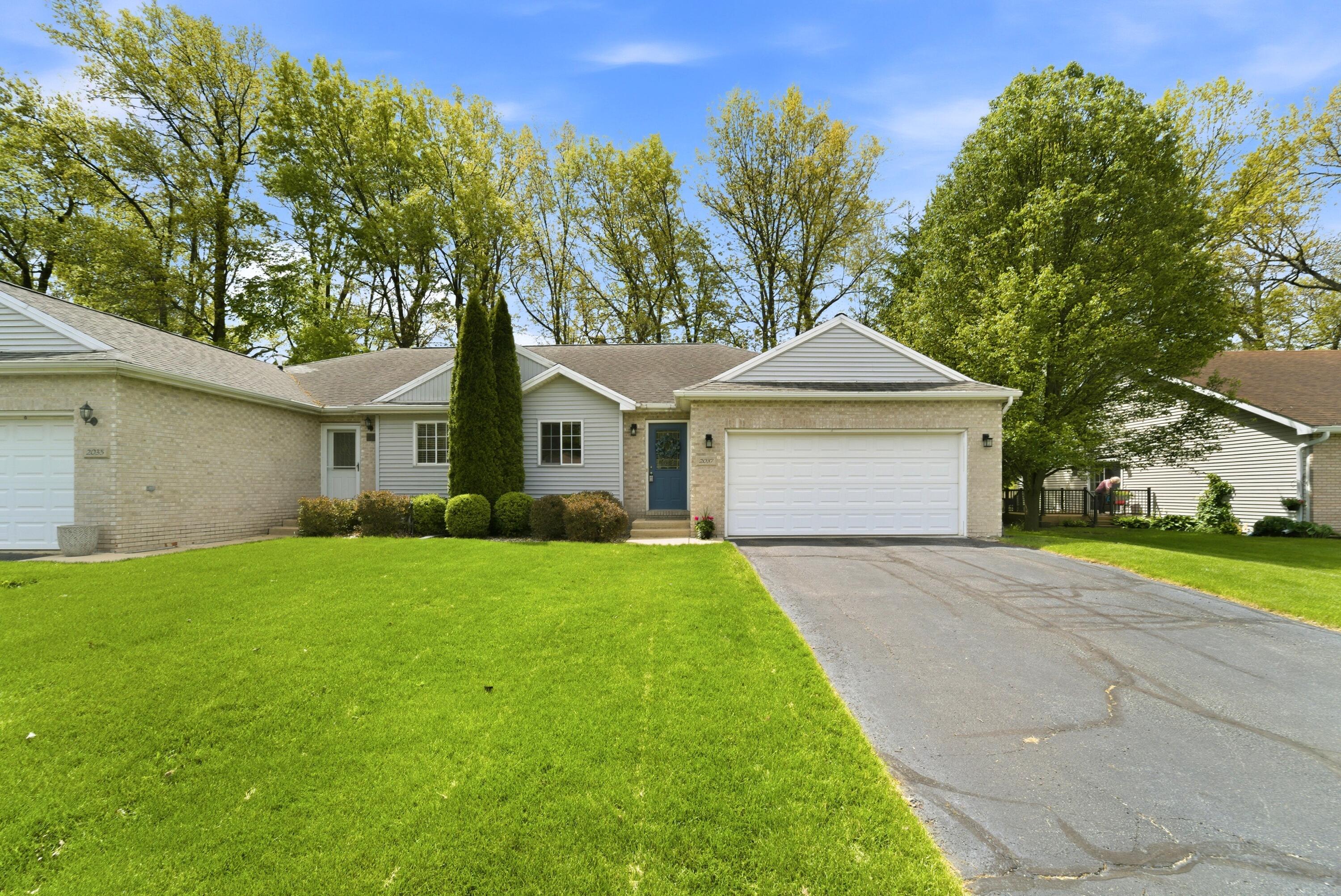 2037 Texas Street Chesterton, IN 46304 - Photo 1 of 26 a front view of a house with a yard and garage