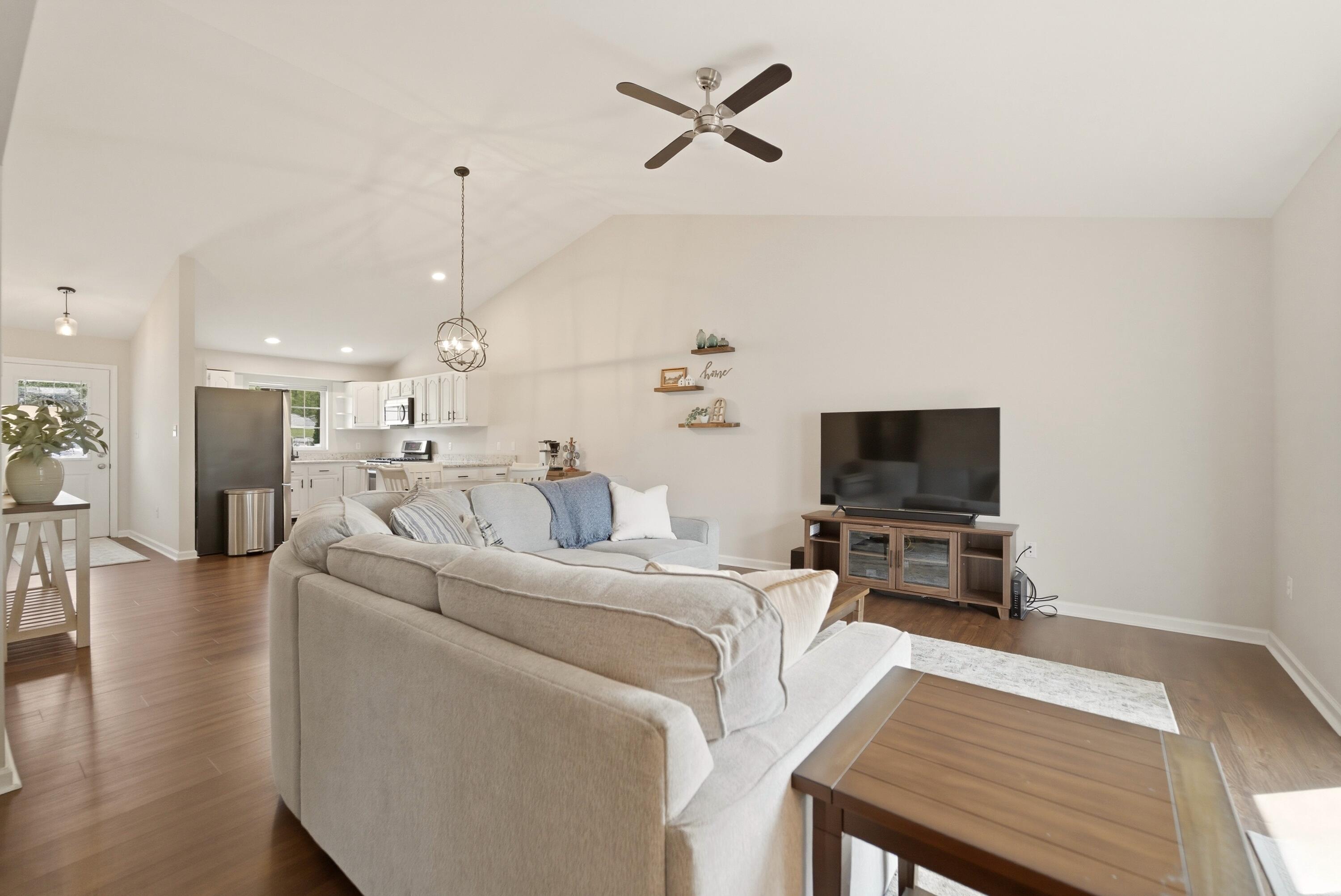 2037 Texas Street Chesterton, IN 46304 - Photo 13 of 26 a living room with furniture a flat screen tv and kitchen view