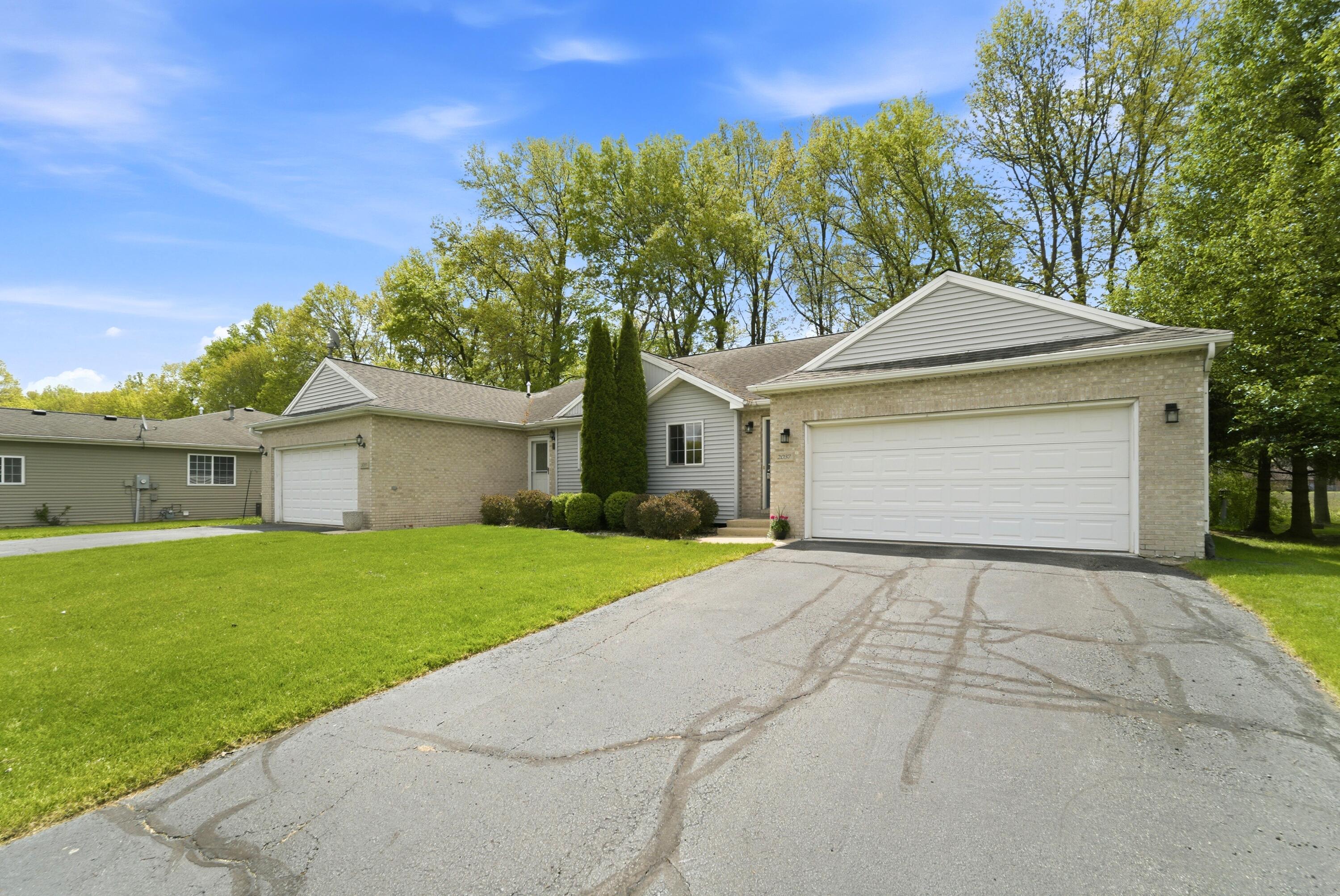 2037 Texas Street Chesterton, IN 46304 - Photo 2 of 26 a front view of a house with a yard and garage