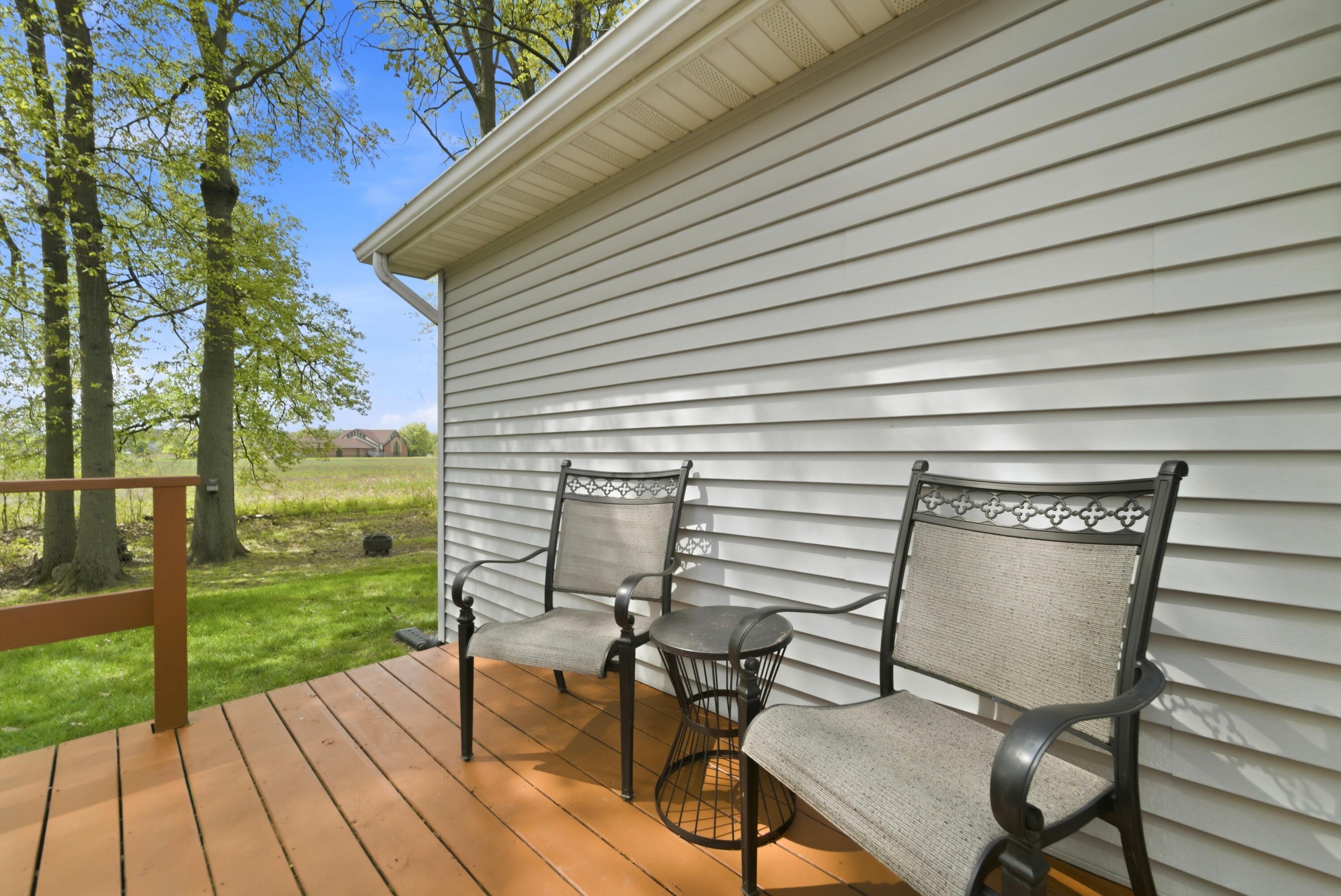 2037 Texas Street Chesterton, IN 46304 - Photo 26 of 26 a view of a patio with table and chairs with wooden floor and fence