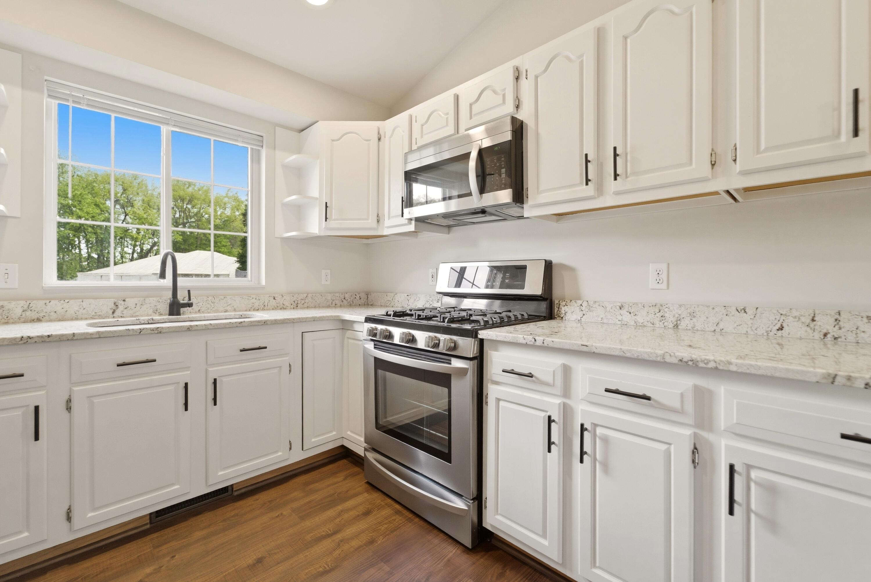 2037 Texas Street Chesterton, IN 46304 - Photo 7 of 26 a kitchen with stainless steel appliances granite countertop white cabinets a sink and a window