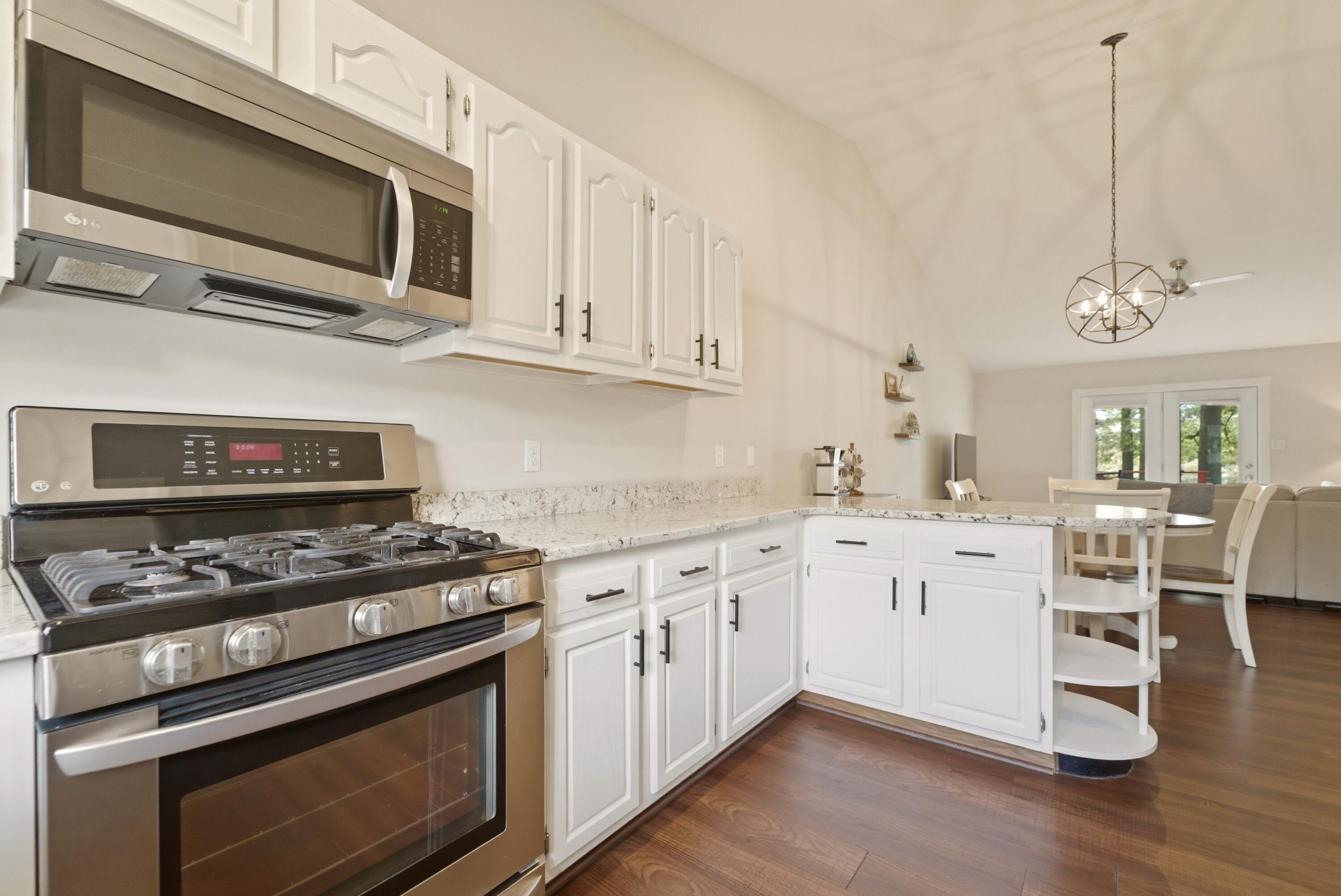 2037 Texas Street Chesterton, IN 46304 - Photo 8 of 26 a kitchen with granite countertop cabinets stainless steel appliances and wooden floor