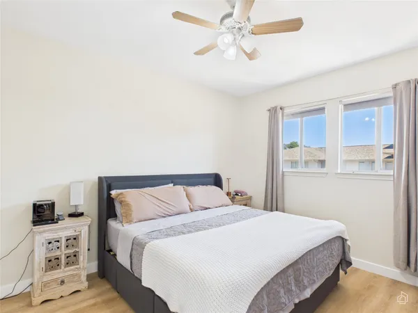 a bedroom with a large bed and a window