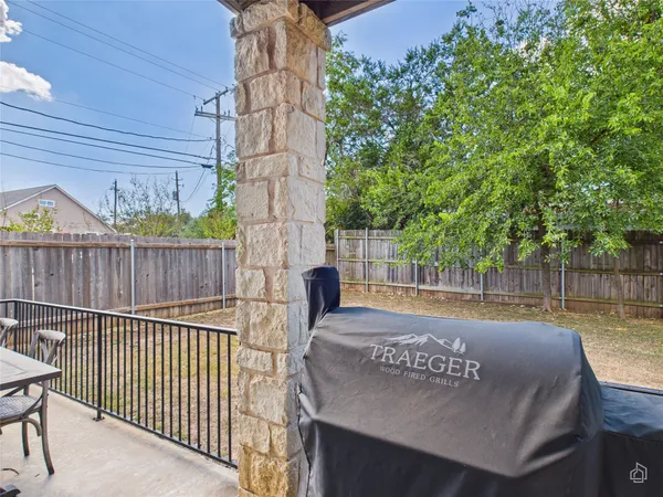 a view of a chairs and table in patio with wooden fence