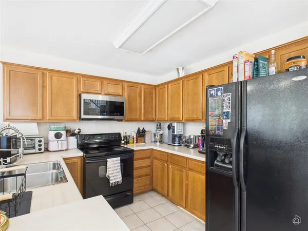 a kitchen with stainless steel appliances granite countertop a refrigerator stove top oven a sink and dishwasher