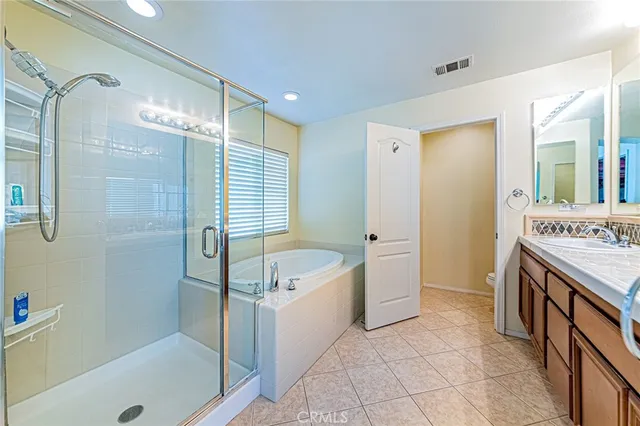 a bathroom with a tub a sink and a mirror