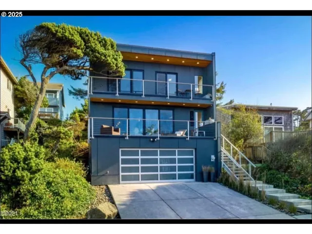 a view of a house with a small yard and wooden fence