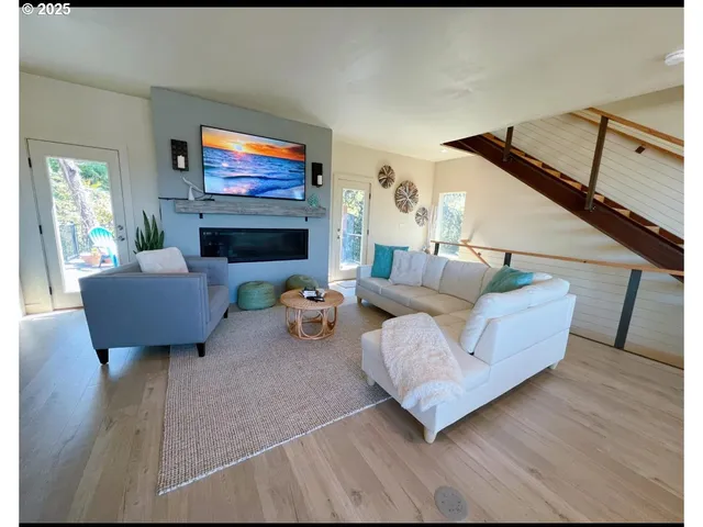 a living room with furniture a rug and a fireplace