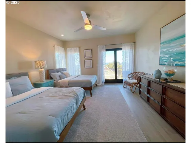 a large bedroom with bed and a large window