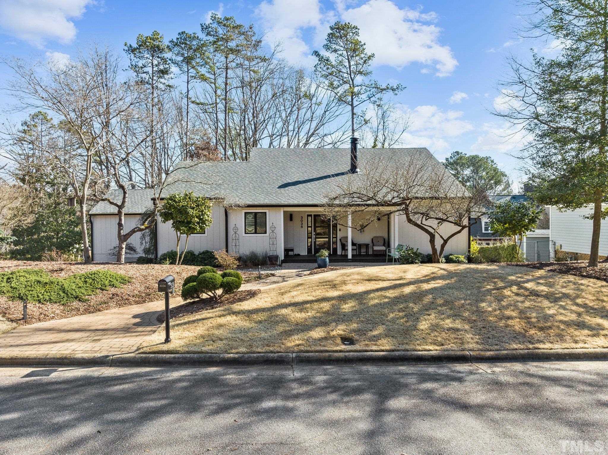 3036 Sylvania Drive Raleigh, NC 27607 - Photo 1 of 59 a front view of a house with a tree