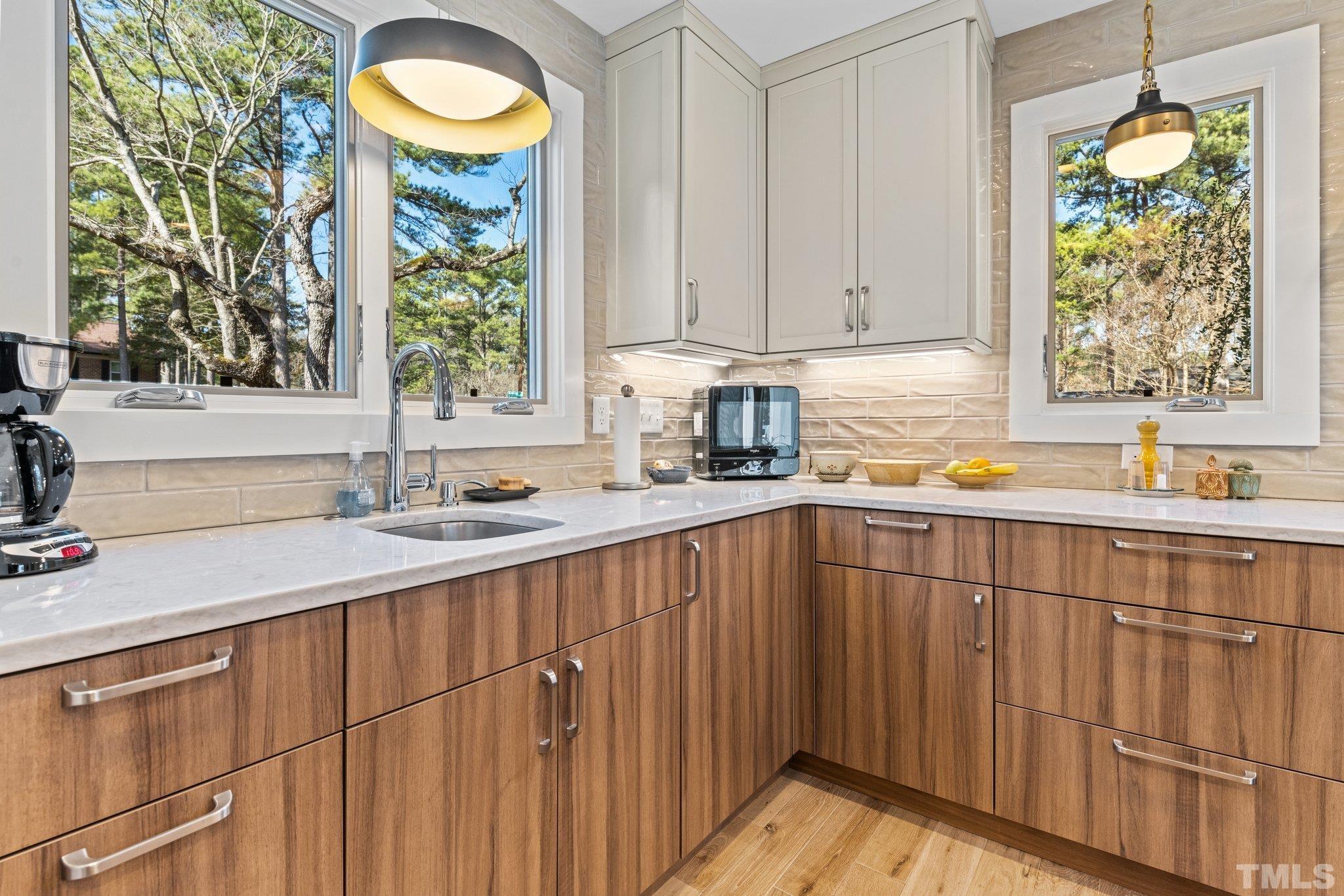 3036 Sylvania Drive Raleigh, NC 27607 - Photo 2 of 59 a kitchen with stainless steel appliances granite countertop a sink and a window