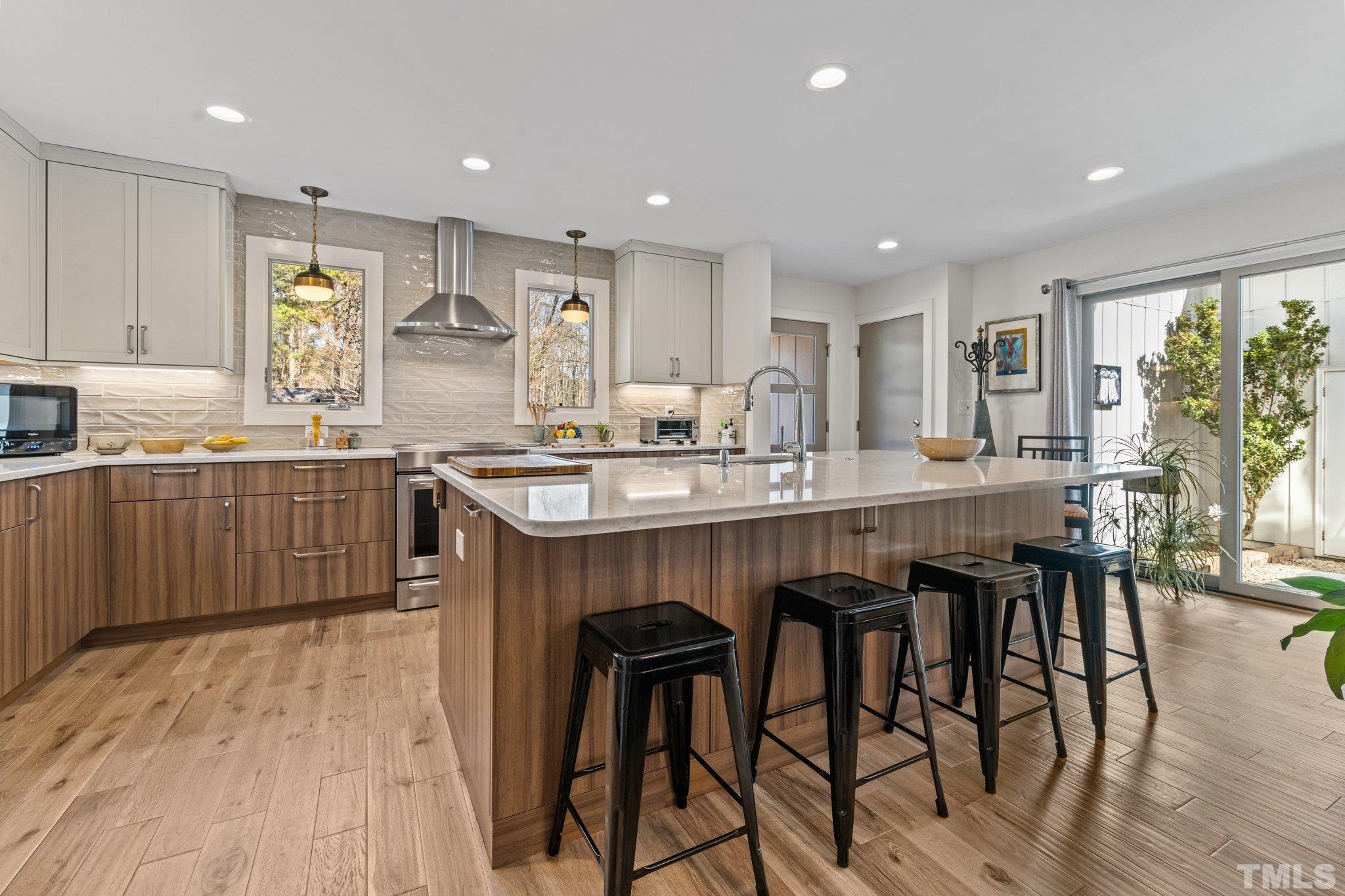 3036 Sylvania Drive Raleigh, NC 27607 - Photo 34 of 59 a kitchen with stainless steel appliances granite countertop a table chairs sink and cabinets