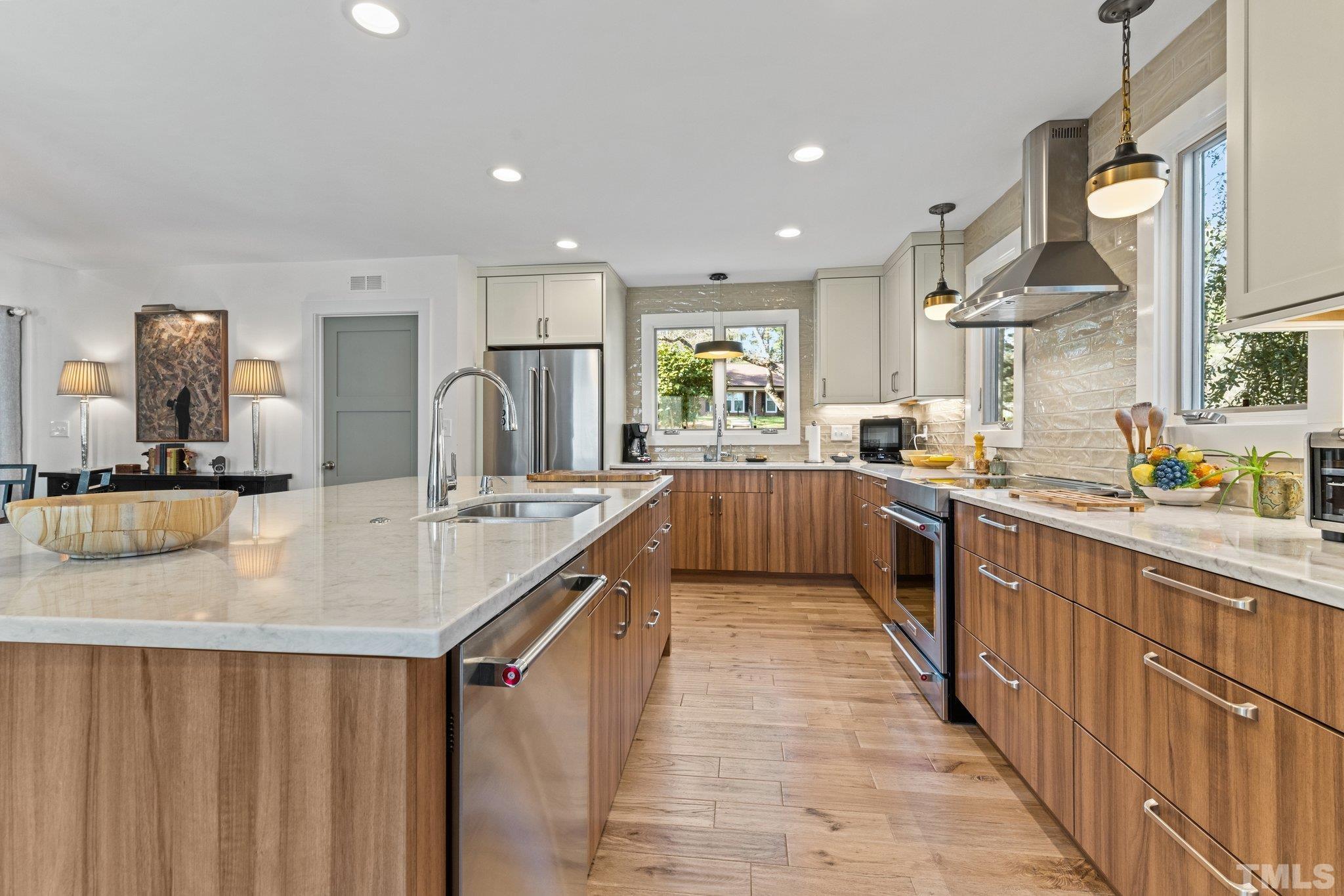 3036 Sylvania Drive Raleigh, NC 27607 - Photo 35 of 59 a large kitchen with stainless steel appliances lots of counter space and a sink