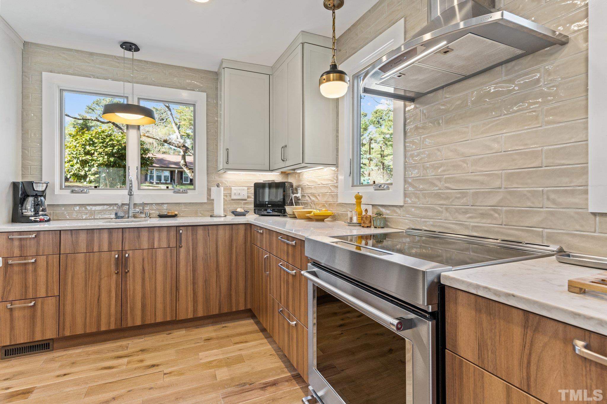 3036 Sylvania Drive Raleigh, NC 27607 - Photo 36 of 59 a kitchen with a sink stove and cabinets