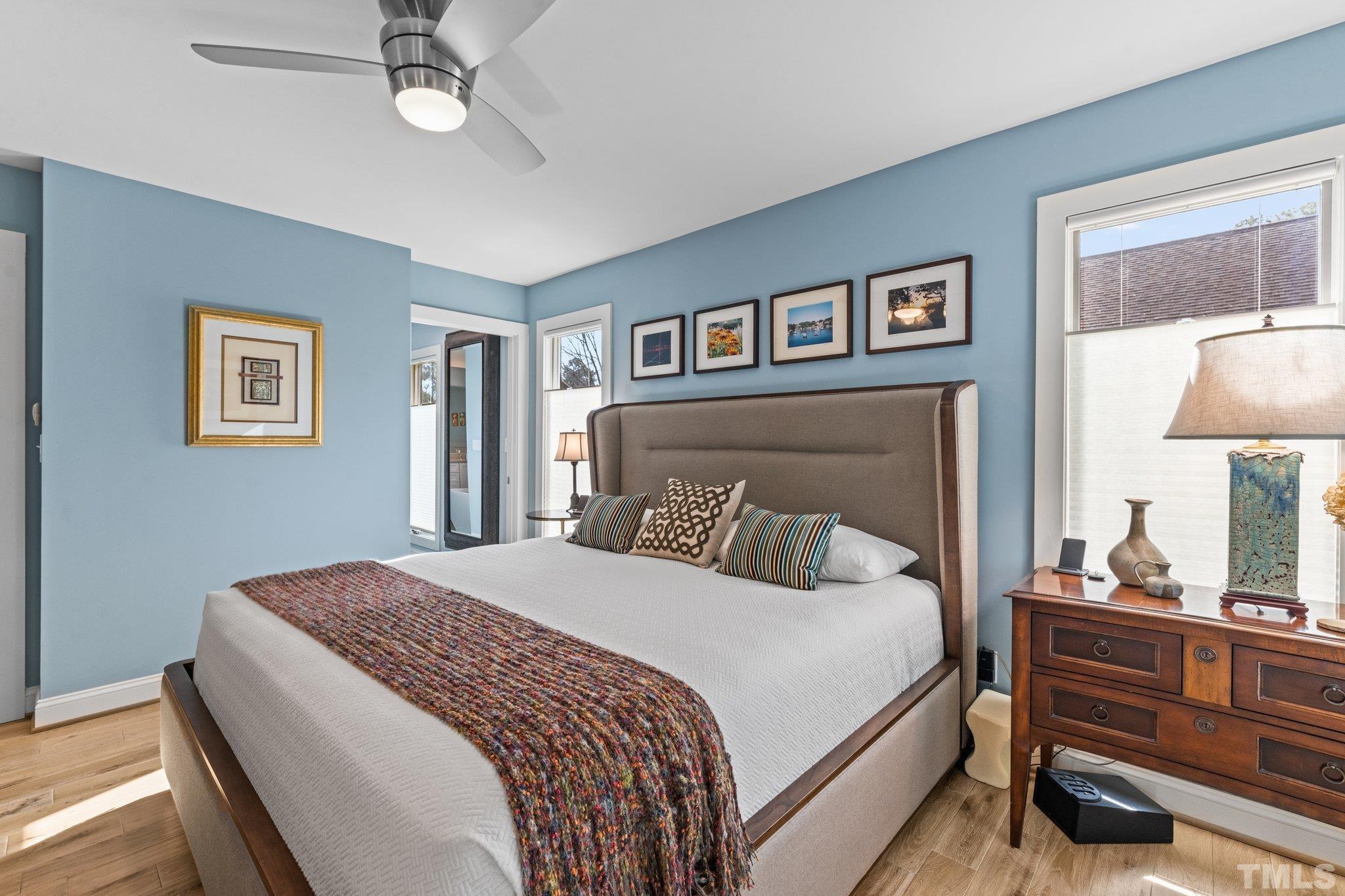 3036 Sylvania Drive Raleigh, NC 27607 - Photo 45 of 59 a bedroom with a large bed and a chandelier