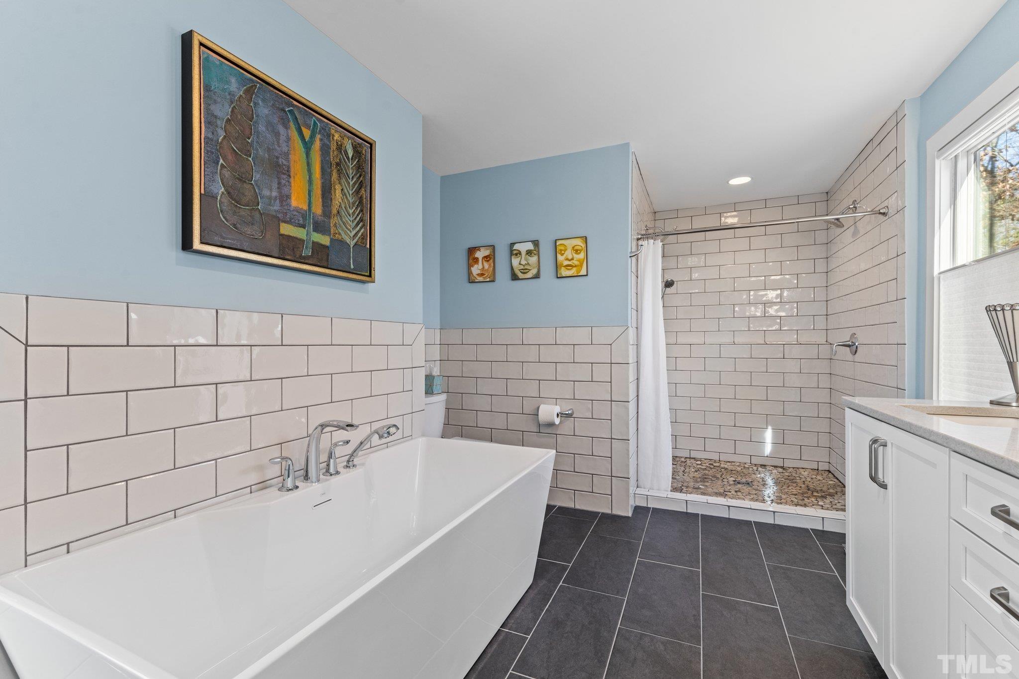 3036 Sylvania Drive Raleigh, NC 27607 - Photo 49 of 59 a bathroom with a bathtub and a shower