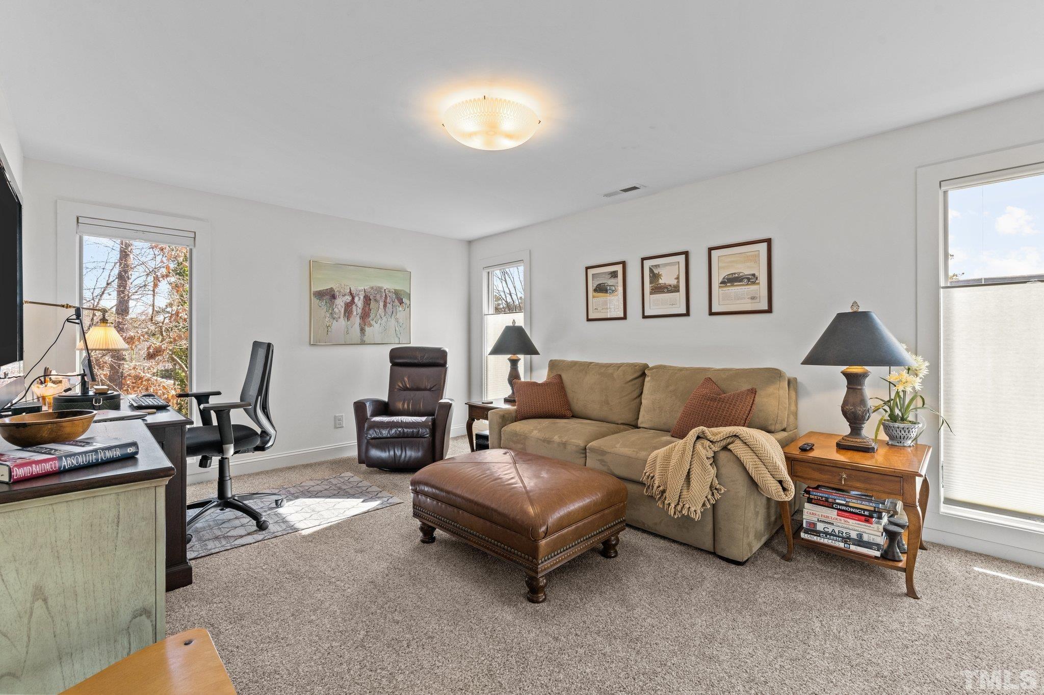 3036 Sylvania Drive Raleigh, NC 27607 - Photo 50 of 59 a living room with furniture a lamp and a window