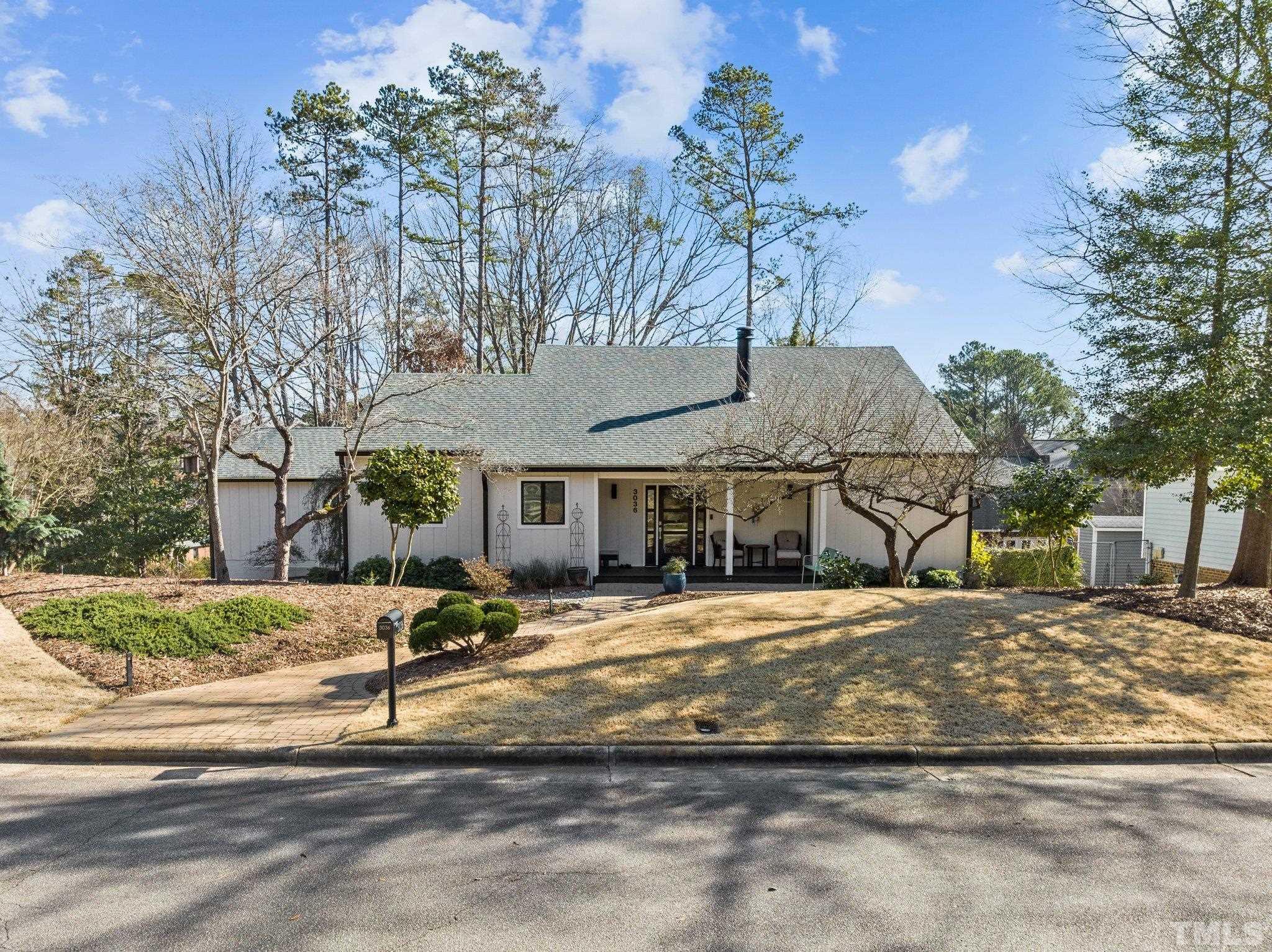 3036 Sylvania Drive Raleigh, NC 27607 - Photo 5 of 59 a front view of a house with a yard