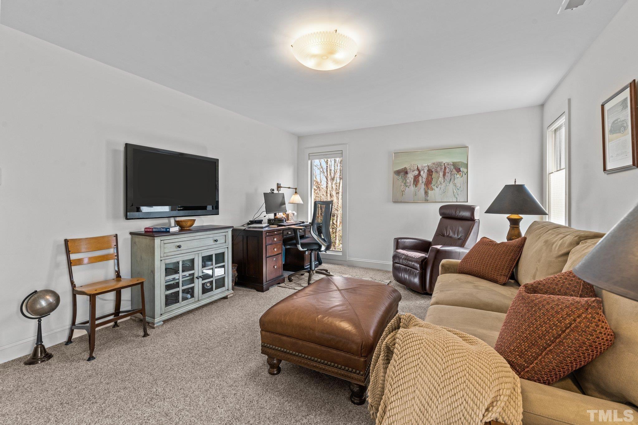 3036 Sylvania Drive Raleigh, NC 27607 - Photo 51 of 59 a living room with furniture and a flat screen tv