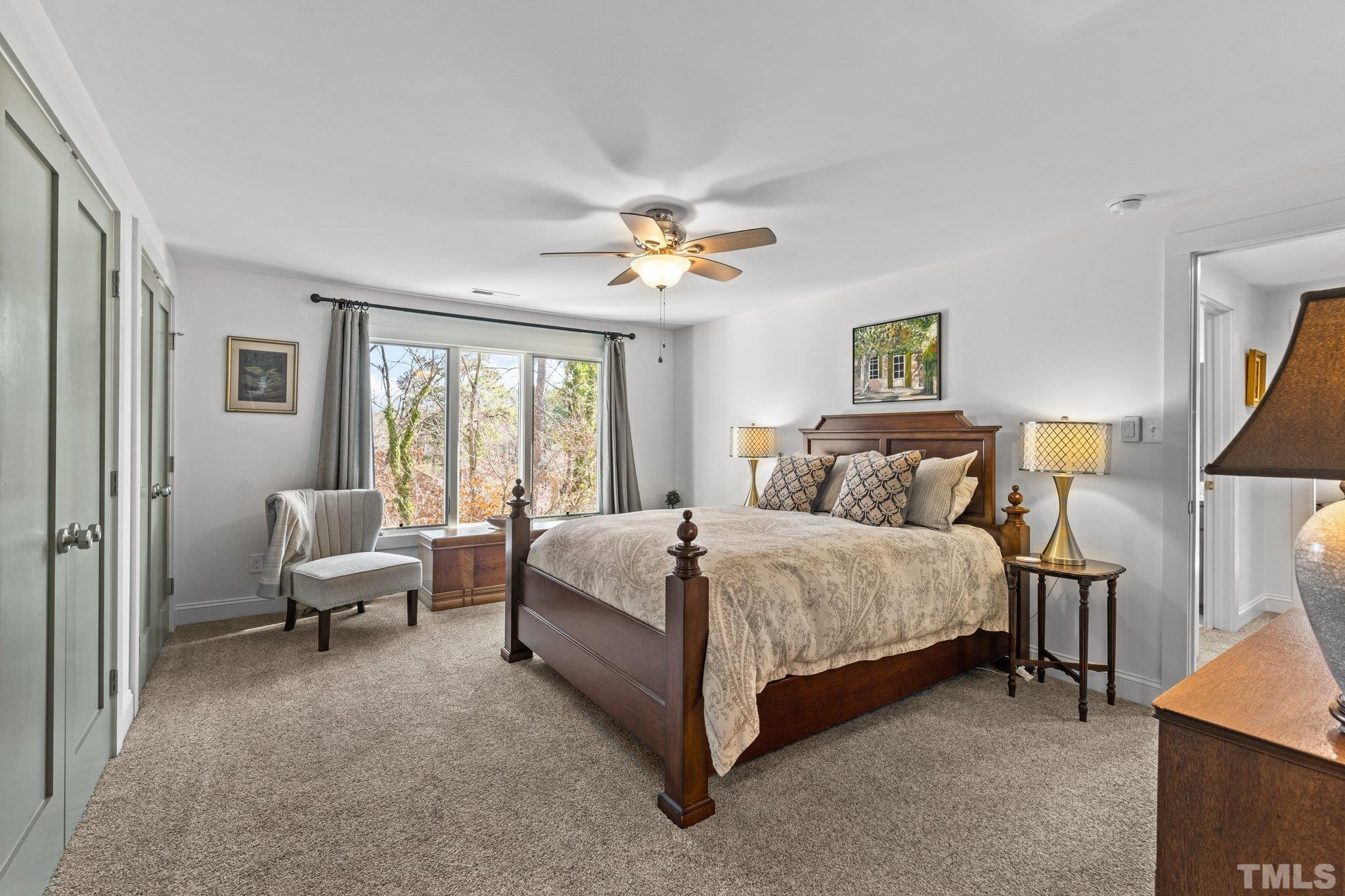 3036 Sylvania Drive Raleigh, NC 27607 - Photo 53 of 59 a spacious bedroom with a bed and a chandelier