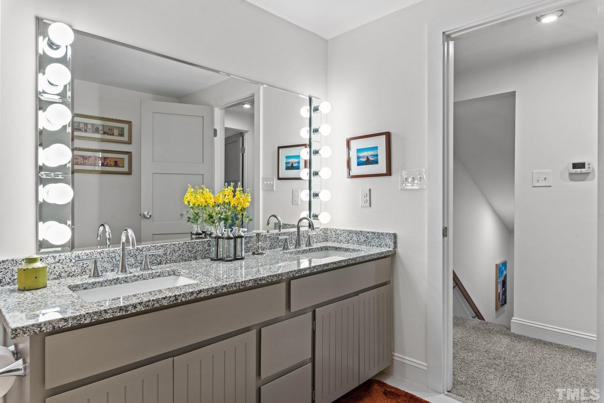 3036 Sylvania Drive Raleigh, NC 27607 - Photo 55 of 59 a bathroom with a granite countertop double vanity sink and a mirror