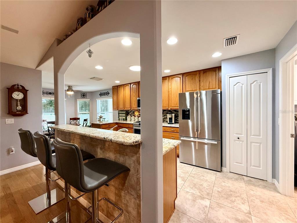 16296 Southwest 15th Court Ocala, FL 34473 - Photo 18 of 70 a kitchen with stainless steel appliances kitchen island granite countertop a refrigerator and cabinets
