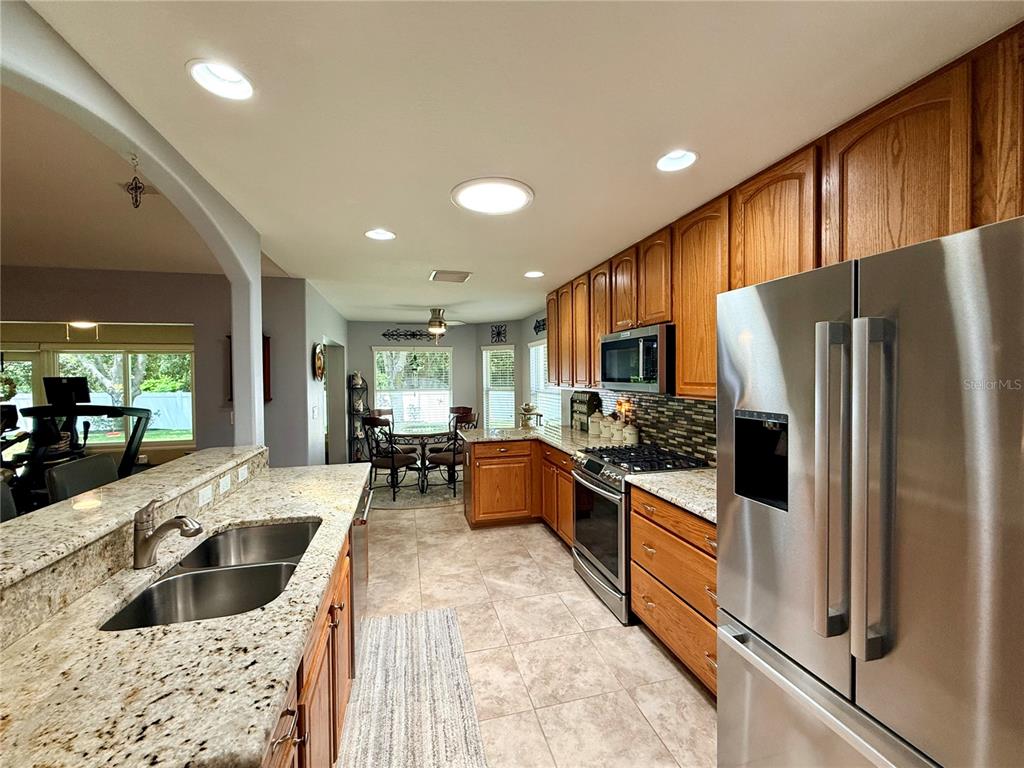 16296 Southwest 15th Court Ocala, FL 34473 - Photo 21 of 70 a kitchen with stainless steel appliances granite countertop a refrigerator and a sink