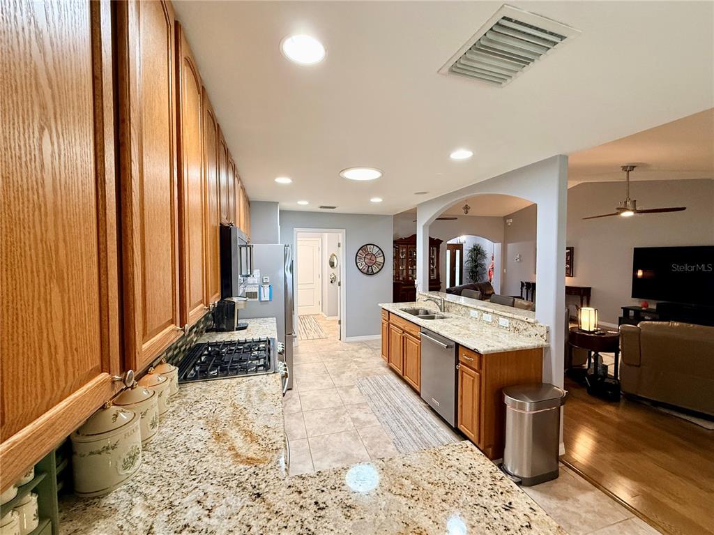 16296 Southwest 15th Court Ocala, FL 34473 - Photo 26 of 70 a large kitchen with kitchen island granite countertop a large counter top and stainless steel appliances