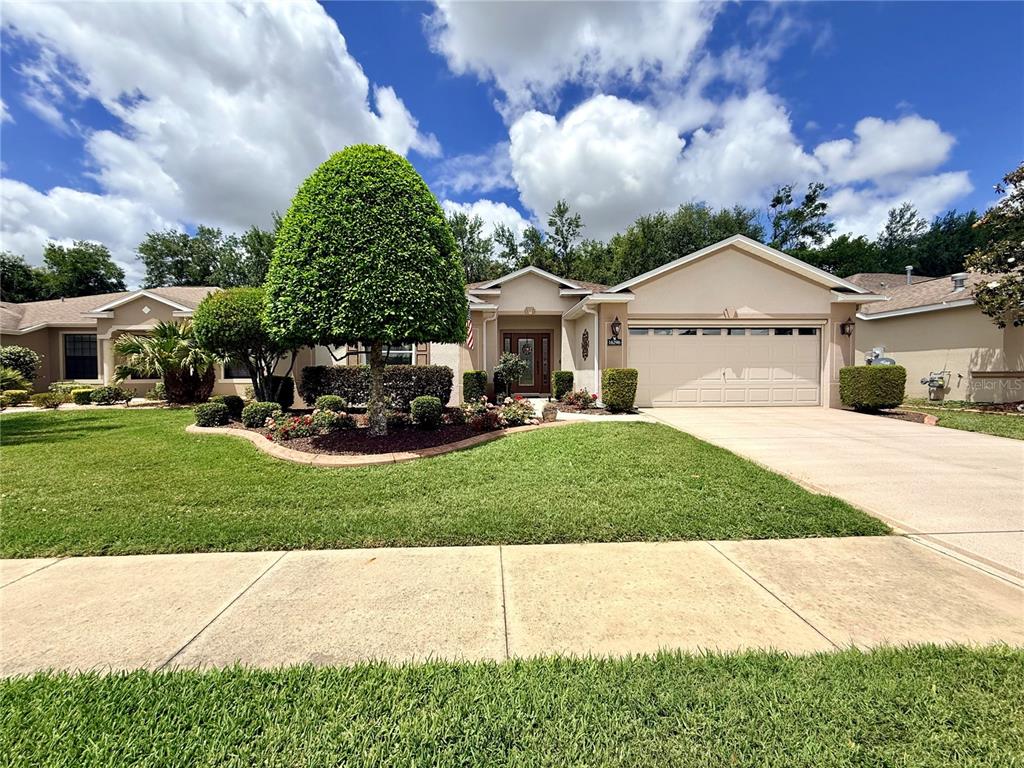 16296 Southwest 15th Court Ocala, FL 34473 - Photo 3 of 70 a front view of a house with a yard