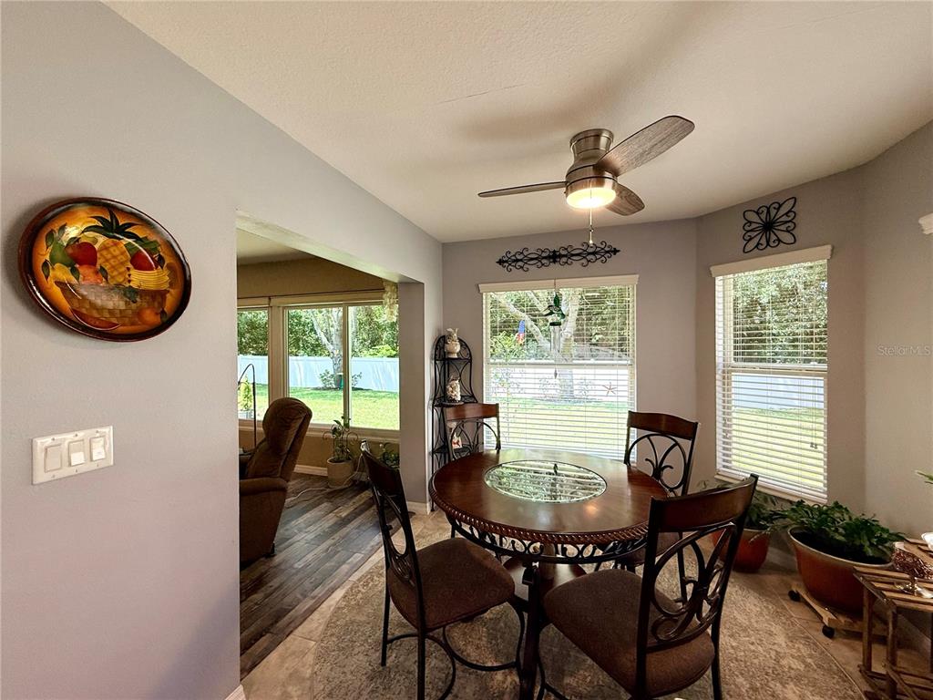 16296 Southwest 15th Court Ocala, FL 34473 - Photo 32 of 70 a dining room with furniture a window and a chandelier