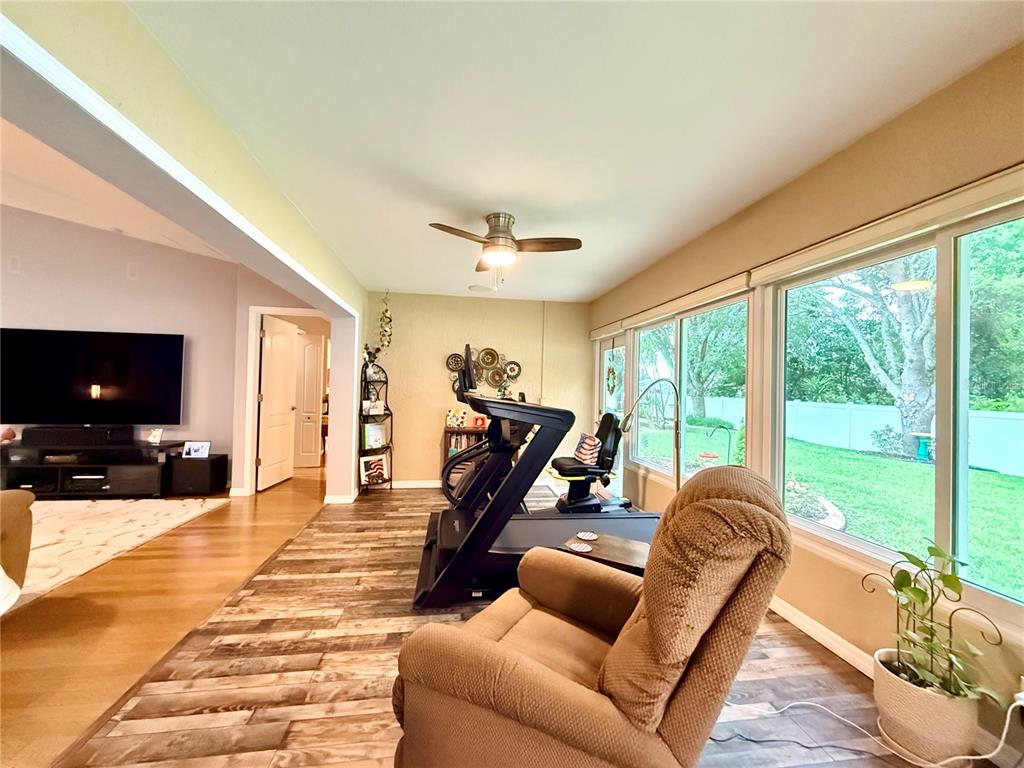 16296 Southwest 15th Court Ocala, FL 34473 - Photo 35 of 70 a living room with furniture and a flat screen tv