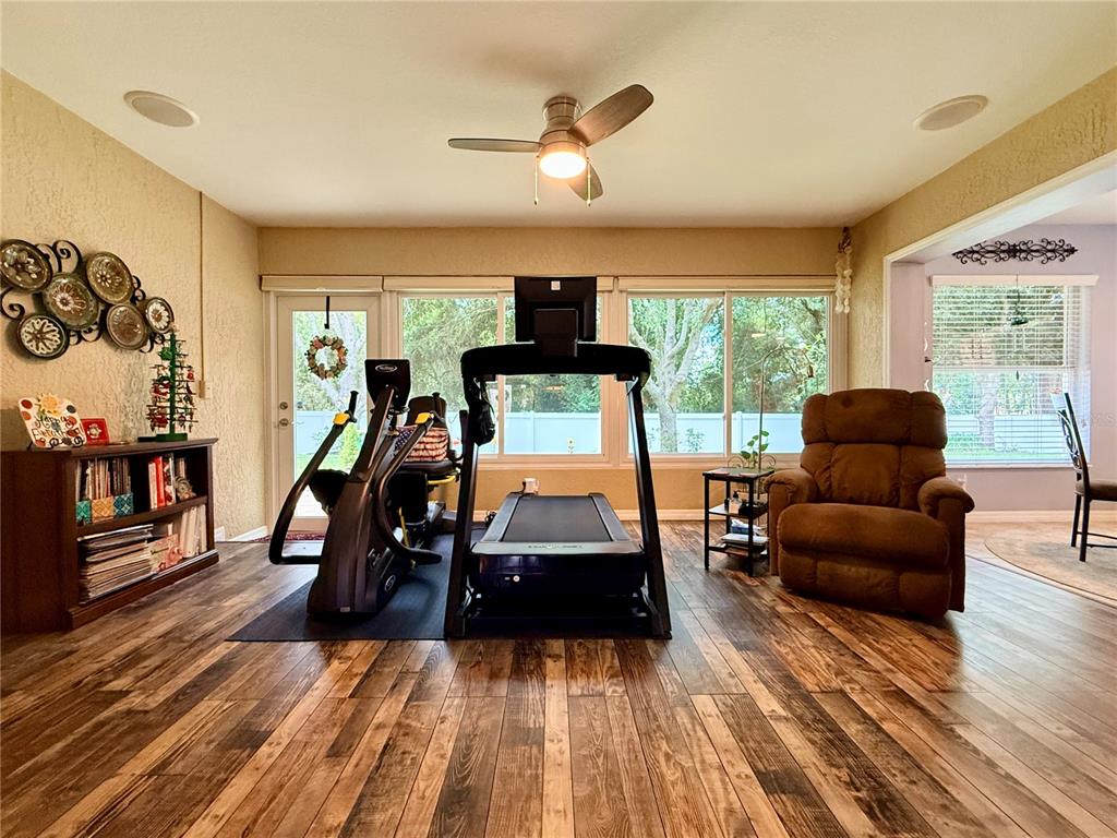 16296 Southwest 15th Court Ocala, FL 34473 - Photo 36 of 70 a living room with furniture and a flat screen tv