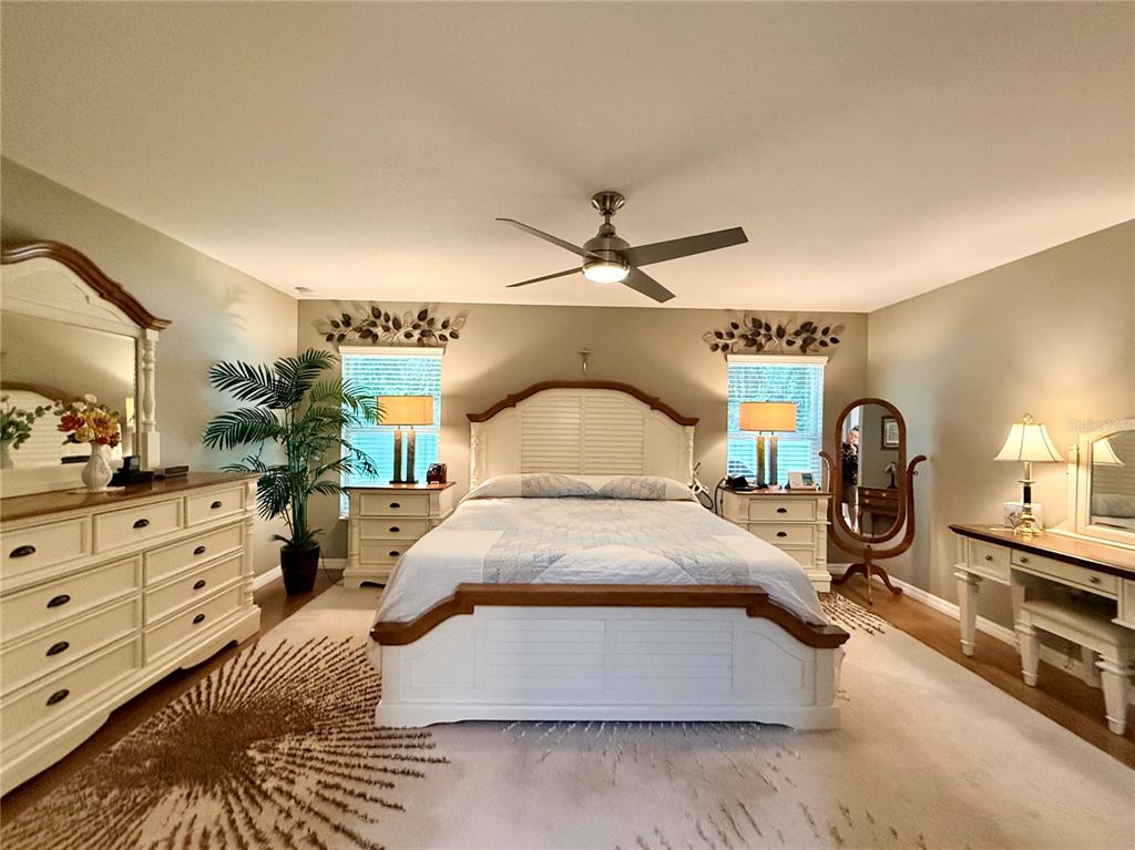 16296 Southwest 15th Court Ocala, FL 34473 - Photo 37 of 70 a bedroom with a bed and a mirror on the dresser
