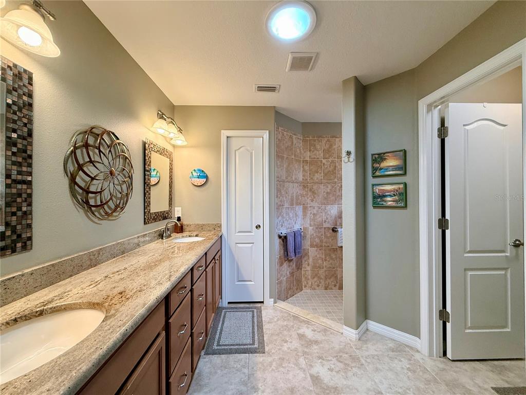 16296 Southwest 15th Court Ocala, FL 34473 - Photo 41 of 70 workspace with a granite countertop sink and a refrigerator