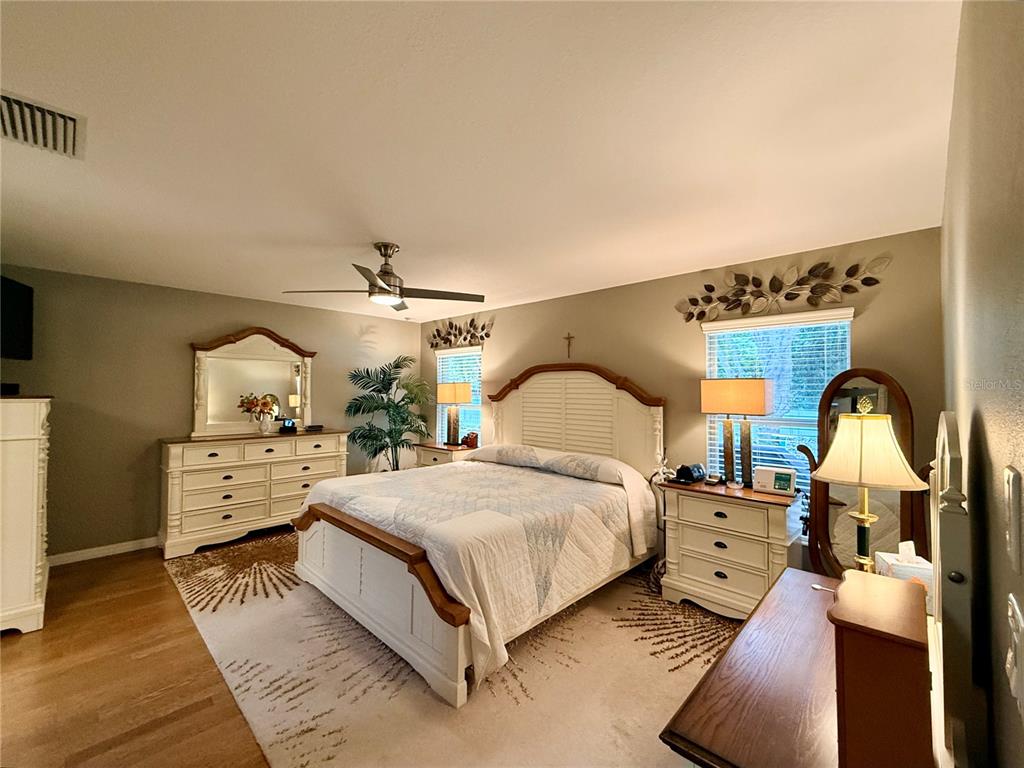 16296 Southwest 15th Court Ocala, FL 34473 - Photo 46 of 70 a bedroom with a bed and wooden floor