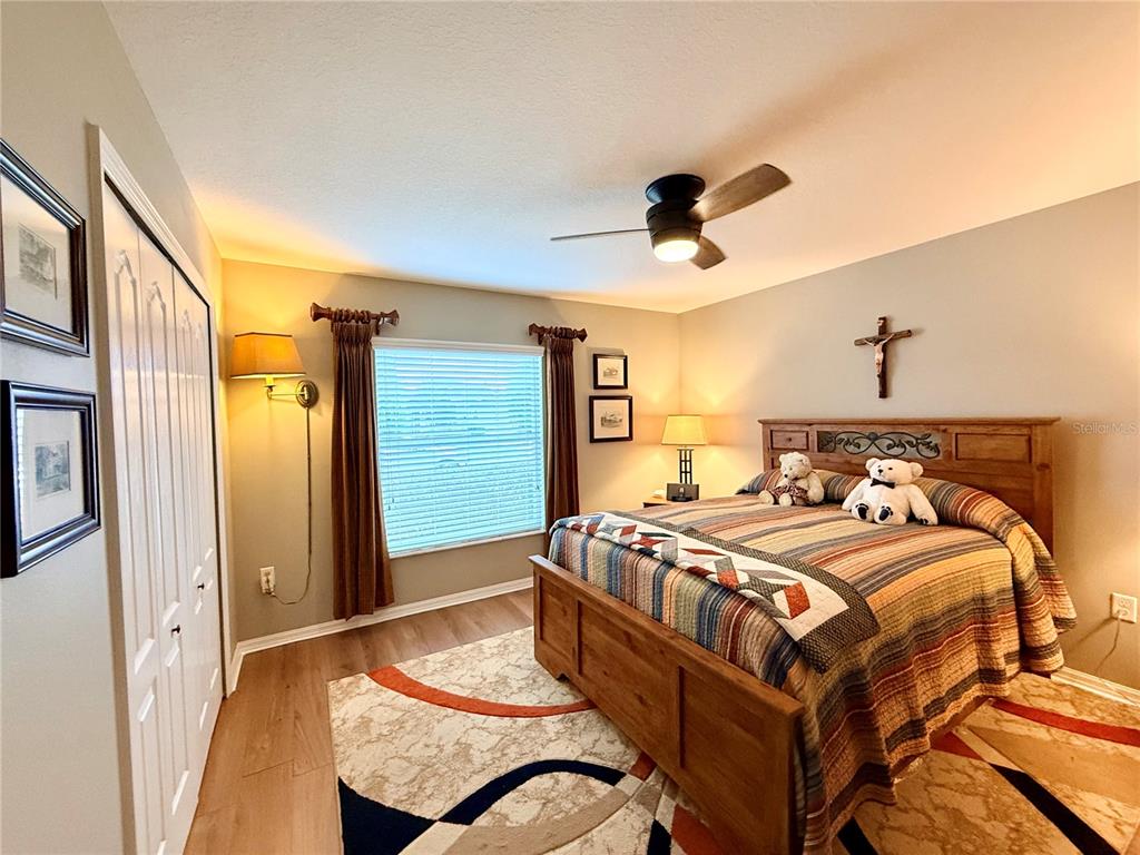 16296 Southwest 15th Court Ocala, FL 34473 - Photo 48 of 70 a bedroom with a bed a dresser and potted plants