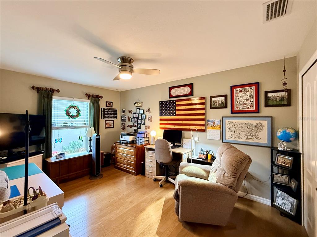 16296 Southwest 15th Court Ocala, FL 34473 - Photo 51 of 70 a living room with furniture and a flat screen tv