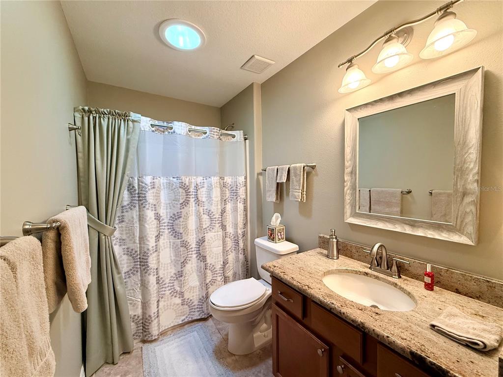 16296 Southwest 15th Court Ocala, FL 34473 - Photo 54 of 70 a bathroom with a granite countertop sink toilet and shower